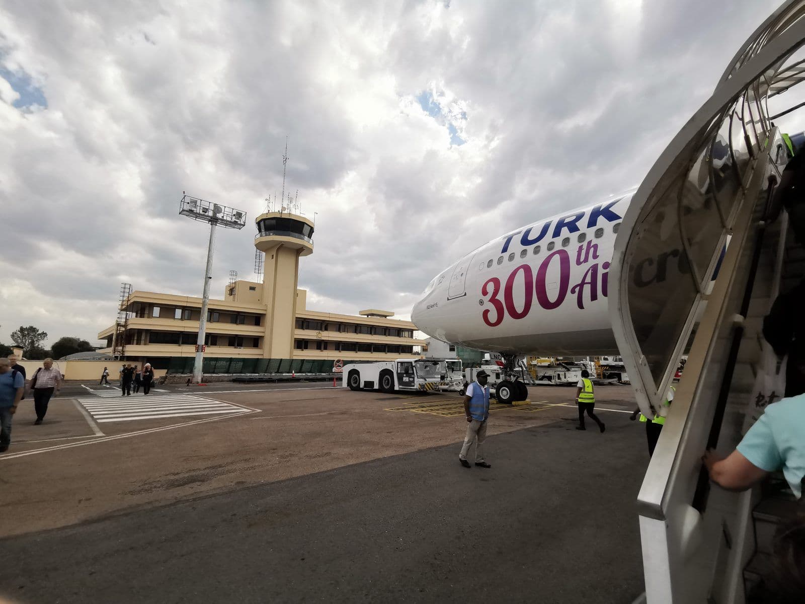 Passagers sur le tarmac de l'aéroport international d'Ivato, à Antananarivo, devant la tour de contrôle